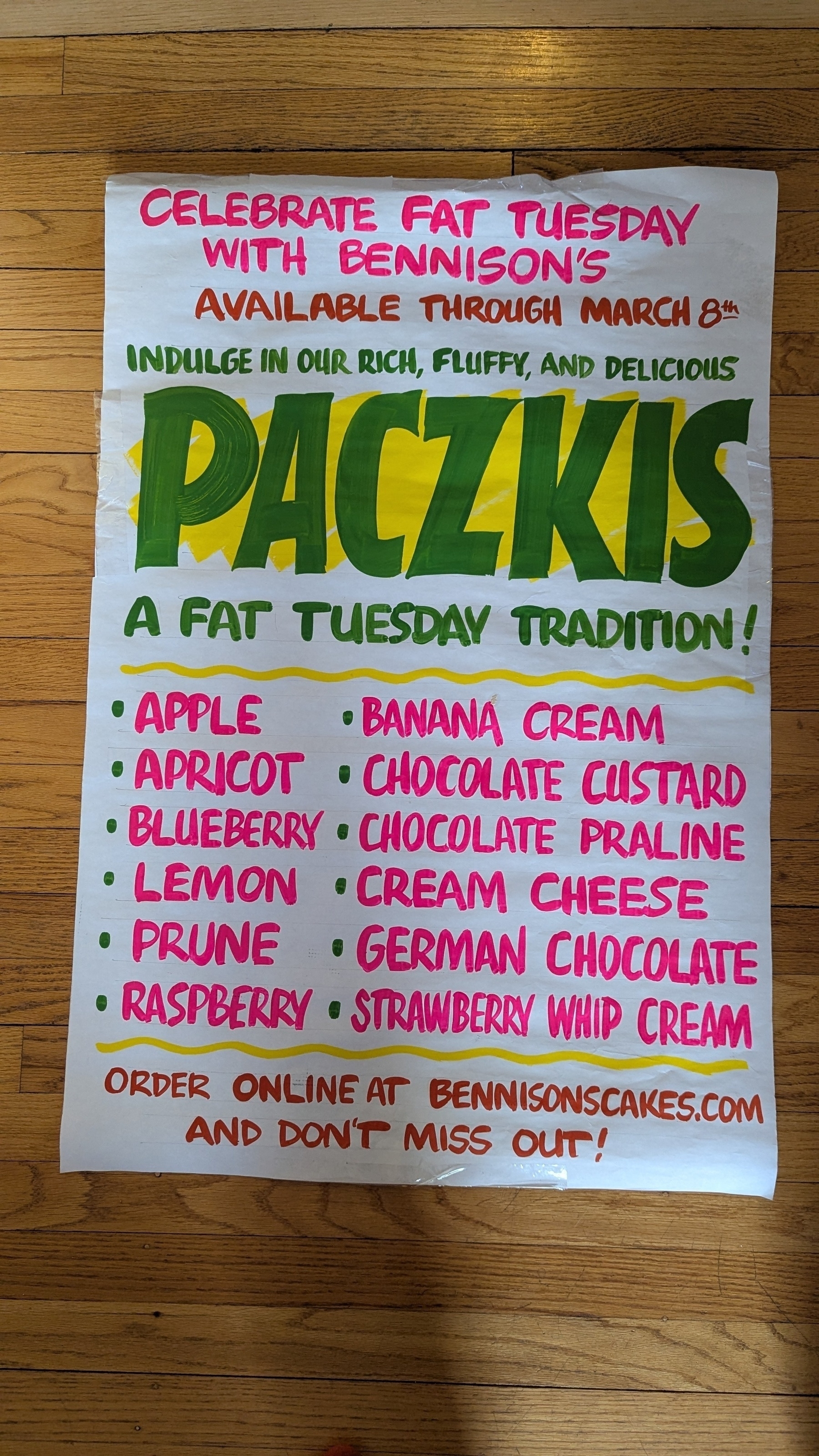 A colorful sign advertises various flavors of Paczkis for Fat Tuesday with emphasis on availability until March 8th.