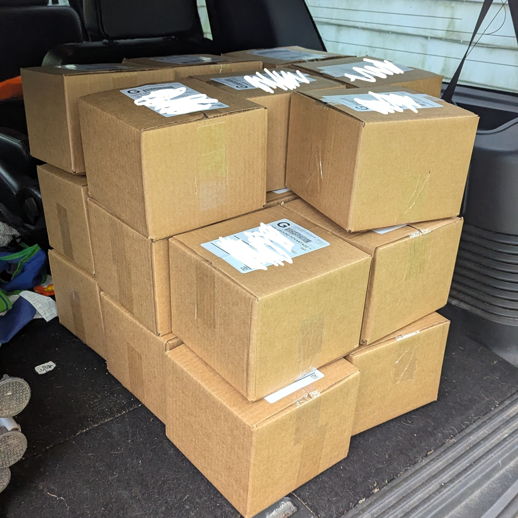 A large pile of boxes in the trunk of a truck 