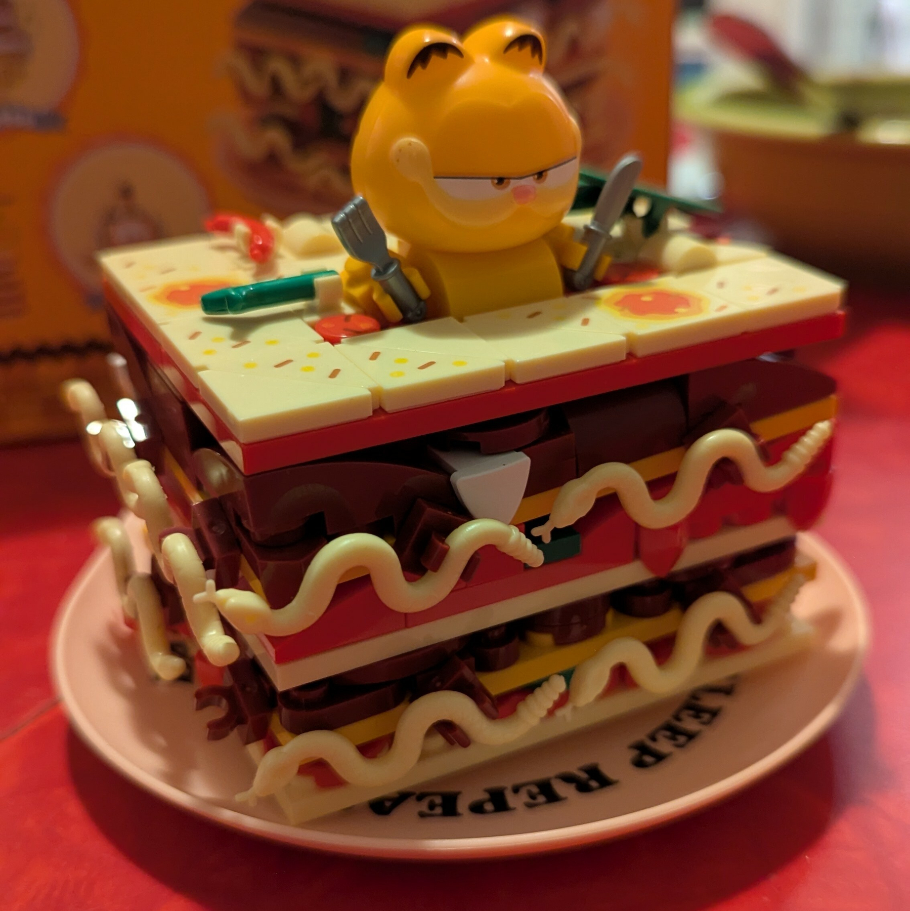 A Lego set of Garfield inside a slice of lasagna 